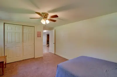 a bedroom with a ceiling fan and a bed at Saratoga Springs Haven with Pool and Fire Pit! in Saratoga Springs
