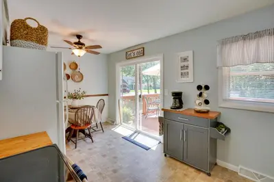 a kitchen and dining room with a table and a ceiling fan at Saratoga Springs Haven with Pool and Fire Pit! in Saratoga Springs