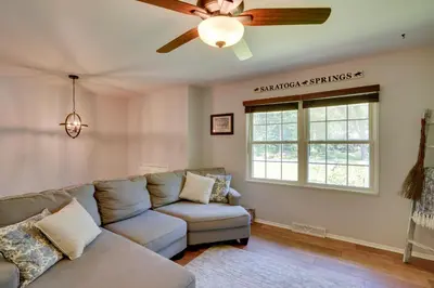 a living room with a couch and a ceiling fan at Saratoga Springs Haven with Pool and Fire Pit! in Saratoga Springs