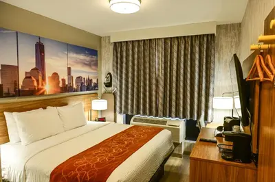 a hotel room with a bed and a large window at Days Inn by Wyndham Bronx NYC in Bronx