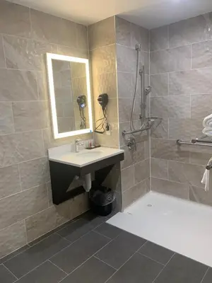 a bathroom with a sink and a shower at Days Inn by Wyndham Bronx NYC in Bronx