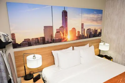 a bedroom with a city skyline mural on the wall at Days Inn by Wyndham Bronx NYC in Bronx