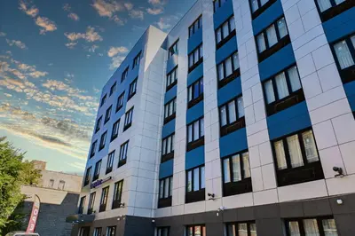 an office building with a sky in the background at Days Inn by Wyndham Bronx NYC in Bronx