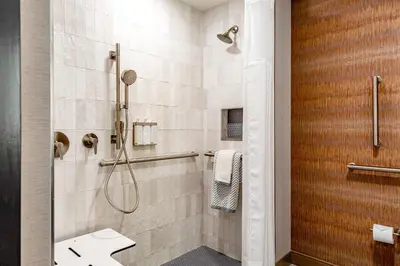 a bathroom with a shower and a sink at Cambria Hotel New Haven University Area in New Haven