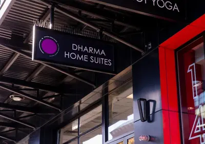 a sign hanging from the ceiling of a store at Dharma Home Suites Hoboken in Hoboken
