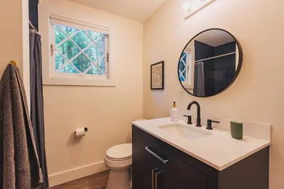 a bathroom with a sink and a mirror at Camp Hudson Pines in Corinth