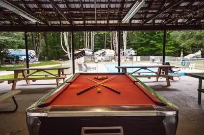 a pool table with two ping pong tables at Camp Hudson Pines in Corinth