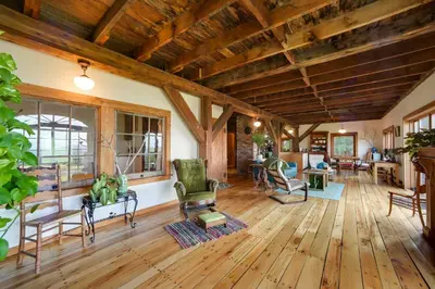 a living room with wooden floors and wooden ceilings at Breathtaking Mtn Views Stylish Rustic Retreat! in Bennington