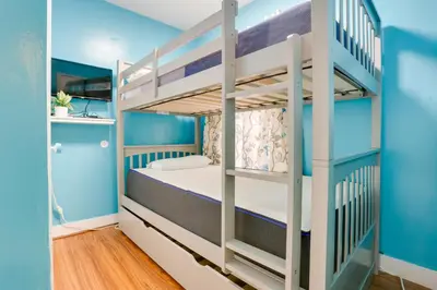 a bunk bed in a room with blue walls at 11 Mi to Manhattan Pet-Friendly Duplex with Yard! in Teaneck