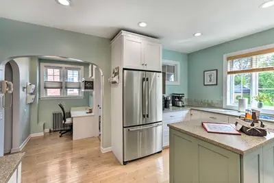 a kitchen with green walls and a stainless steel refrigerator at Walkable New Haven Retreat with Ocean Views! in New Haven