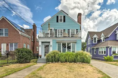 a blue house in a row of houses at Walkable New Haven Retreat with Ocean Views! in New Haven