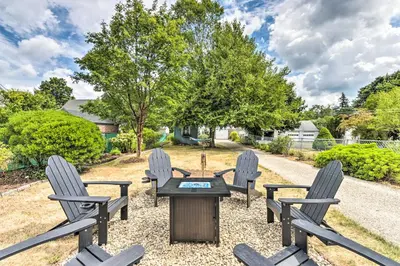 a patio with four chairs and a table with a grill at Walkable New Haven Retreat with Ocean Views! in New Haven