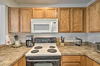 a kitchen with a stove and a microwave at Tannersville Townhome, Near Camelback Mtn! in Tannersville