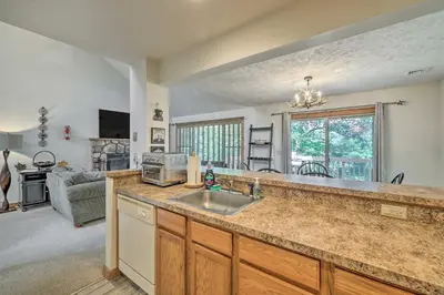 a kitchen with a sink and a living room at Tannersville Townhome, Near Camelback Mtn! in Tannersville