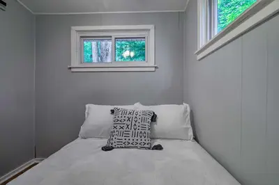 a small bedroom with a bed with a window at 22 Mi to Ski Big Bear! Lake Wallenpaupack Getaway in Greentown