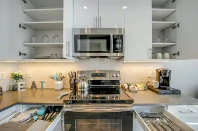 a kitchen with a stove and a microwave at Stylish 1br Unit. Parking. Easy Ride to NYC in Hackensack