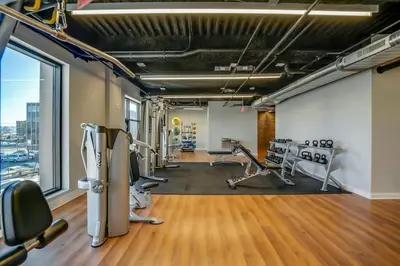 a gym with treadmills and exercise equipment in a building at Stylish 1br Unit. Parking. Easy Ride to NYC in Hackensack