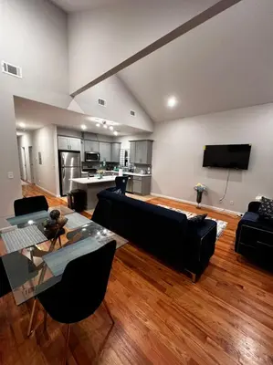 a living room with a couch and a table at SPRINGVIEW HOMES 12MINS FROM EWR & 3 MINS FROM UNIVERSITY HOSPITAL in Newark
