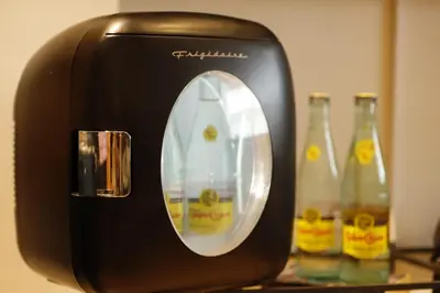 a black toaster sitting on a counter with two bottles at The Vine on Main in Stamford