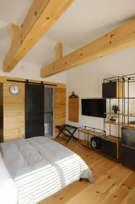 a bedroom with a bed and a flat screen tv at The Vine on Main in Stamford