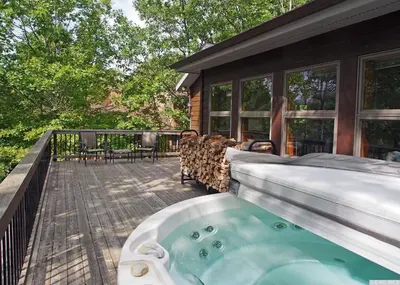 a hot tub on the back of a house at Mountaintop Lookout with Hot Tub under the Stars in Hunter