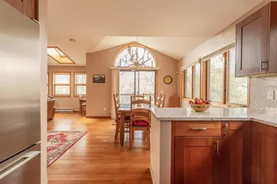a kitchen and dining room with a table and chairs at Mountaintop Lookout with Hot Tub under the Stars in Hunter