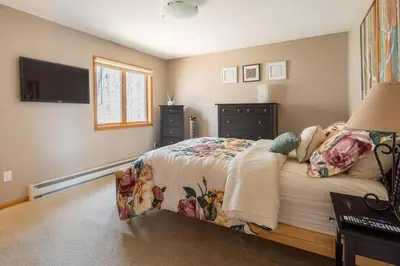 a bedroom with a bed and a television in it at Mountaintop Lookout with Hot Tub under the Stars in Hunter