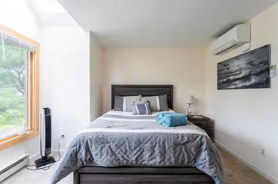 a bedroom with a bed and a window at Redwood Retreat in Windham - minutes to Mtn! in Windham