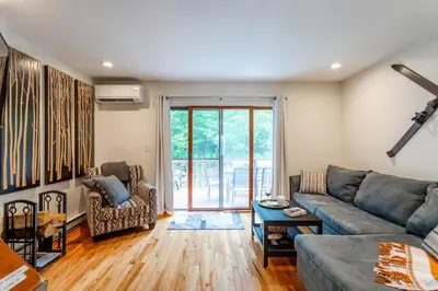 a living room with a couch and a table at Redwood Retreat in Windham - minutes to Mtn! in Windham