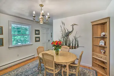 a dining room with a table and chairs and a chandelier at Stockbridge Home Walk to Town Beach! in Stockbridge