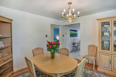 a dining room with a table and chairs and a vase of flowers at Stockbridge Home Walk to Town Beach! in Stockbridge