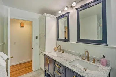 a bathroom with two sinks and a mirror at Stockbridge Home Walk to Town Beach! in Stockbridge