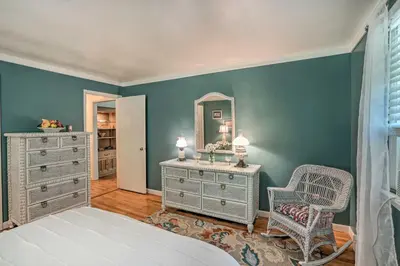 a bedroom with a mirror and a dresser and a chair at Stockbridge Home Walk to Town Beach! in Stockbridge