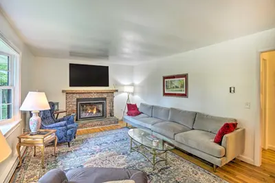 a living room with a couch and a fireplace at Stockbridge Home Walk to Town Beach! in Stockbridge