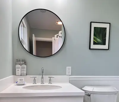 a white bathroom with a sink and a mirror at Blue Vista Motor Lodge in Florida