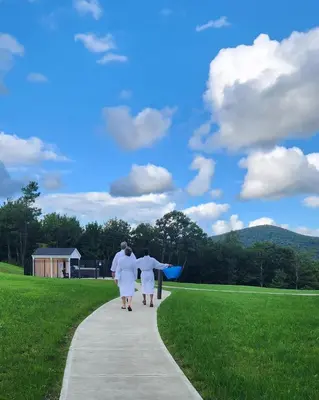 two women walking down a sidewalk at Blue Vista Motor Lodge in Florida