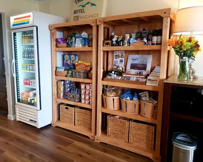 a wooden book shelf in a kitchen next to a refrigerator at Blue Vista Motor Lodge in Florida