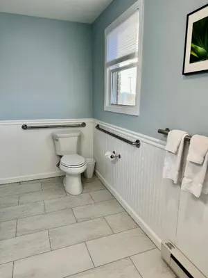 a bathroom with a toilet and a window at Blue Vista Motor Lodge in Florida