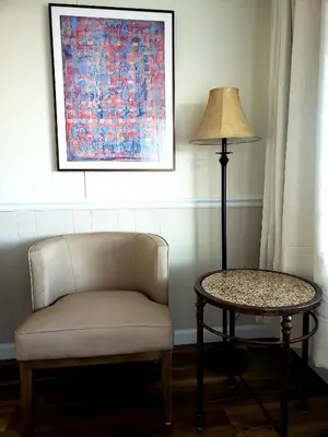 a chair and a lamp in a room with a table at Blue Vista Motor Lodge in Florida