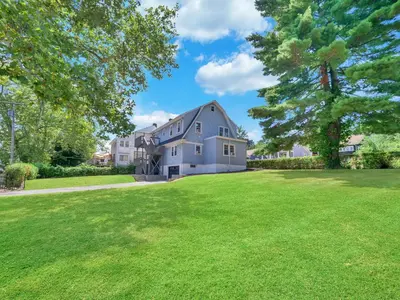 a large white house with a large yard at Deck View of Hudson River & Mt Beacon / Boho Suite in Newburgh