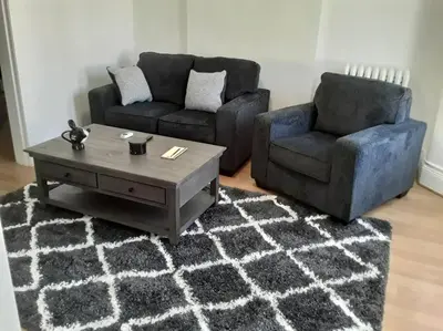 a living room with two couches and a coffee table at Warm 3 BR for U Near Manhattan View, 15 Min to NYC in West New York