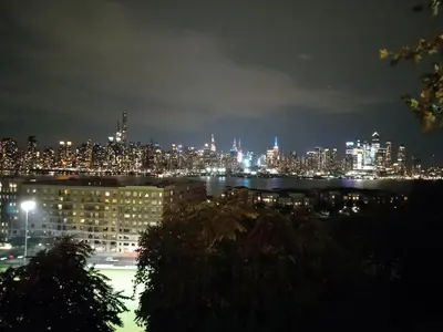 a view of a city at night with at Warm 3 BR for U Near Manhattan View, 15 Min to NYC in West New York