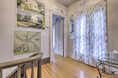 a dining room with a glass table and a window at Charming Springfield Apt Less Than 2 Mi to Downtown! in Springfield