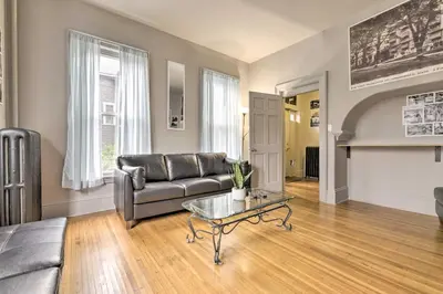 a living room with a couch and a glass table at Charming Springfield Apt Less Than 2 Mi to Downtown! in Springfield