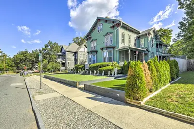 a blue house on a street with bushes at Charming Springfield Apt Less Than 2 Mi to Downtown! in Springfield