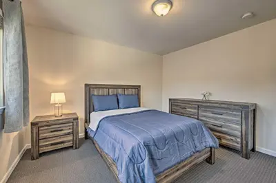 a bedroom with a large bed and two night stands at Glen Cove Home Walk to Boardwalk and Dining! in Glen Cove