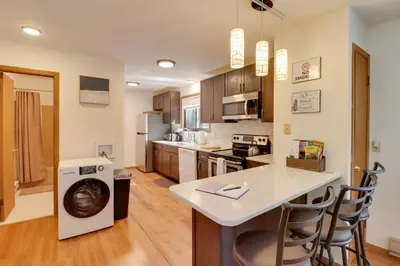 a kitchen with a washing machine in the middle of a room at Poconos Cabin Serene Deck, Fire Pit and Game Room in Tobyhanna