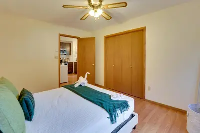 a bedroom with a bed and a ceiling fan at Poconos Cabin Serene Deck, Fire Pit and Game Room in Tobyhanna