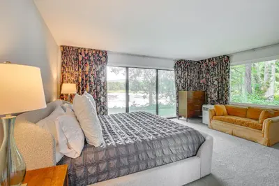 a bedroom with a bed and a couch and a window at Water-View Home in the Berkshires in Sheffield