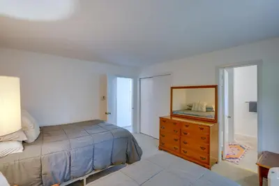 a bedroom with a bed and a dresser and a mirror at Water-View Home in the Berkshires in Sheffield